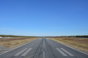 an airport runway with a clear blue sky